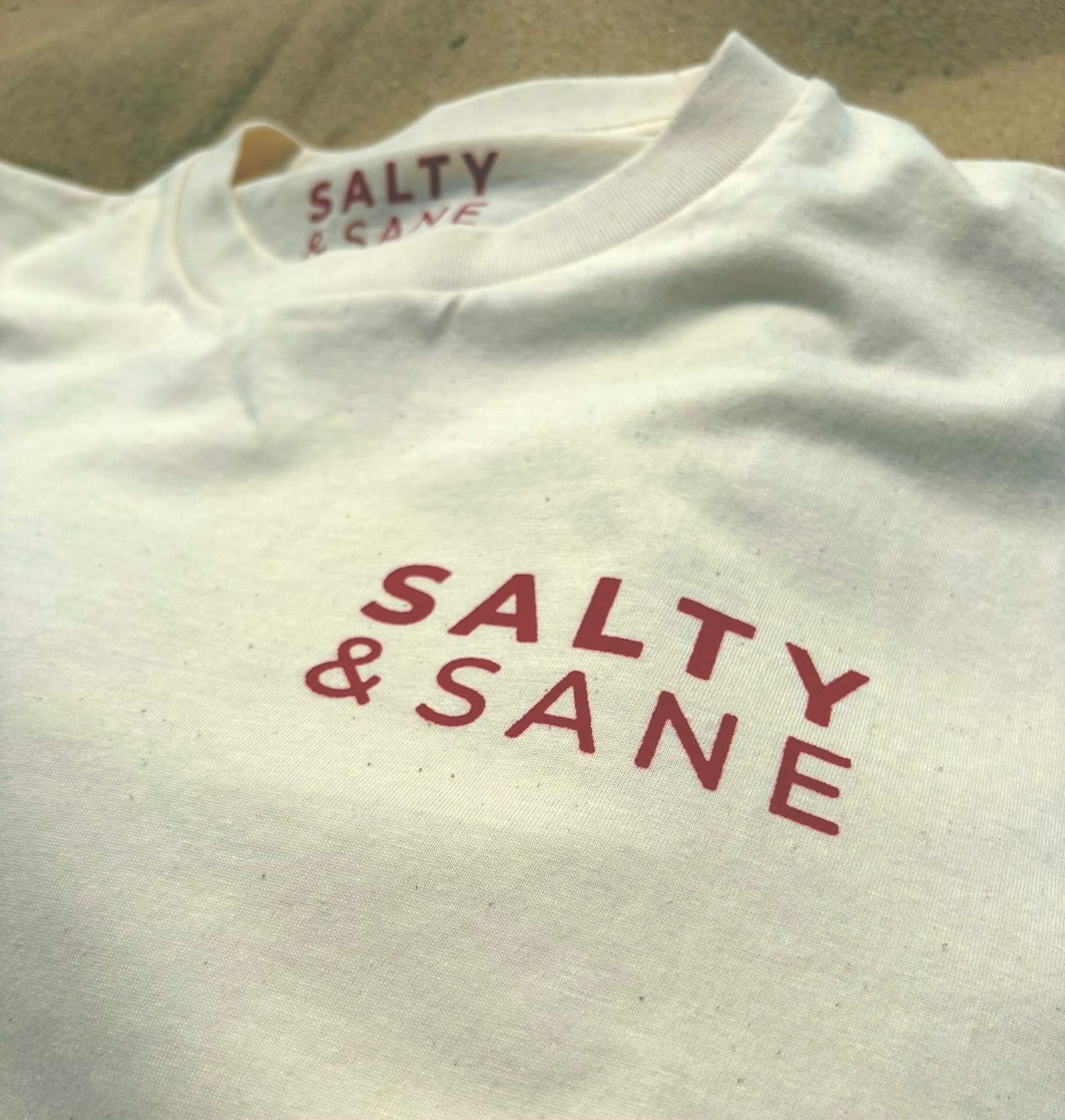 Salty & Sane chest logo on Cropped Oversized Afterglow Club T-shirt