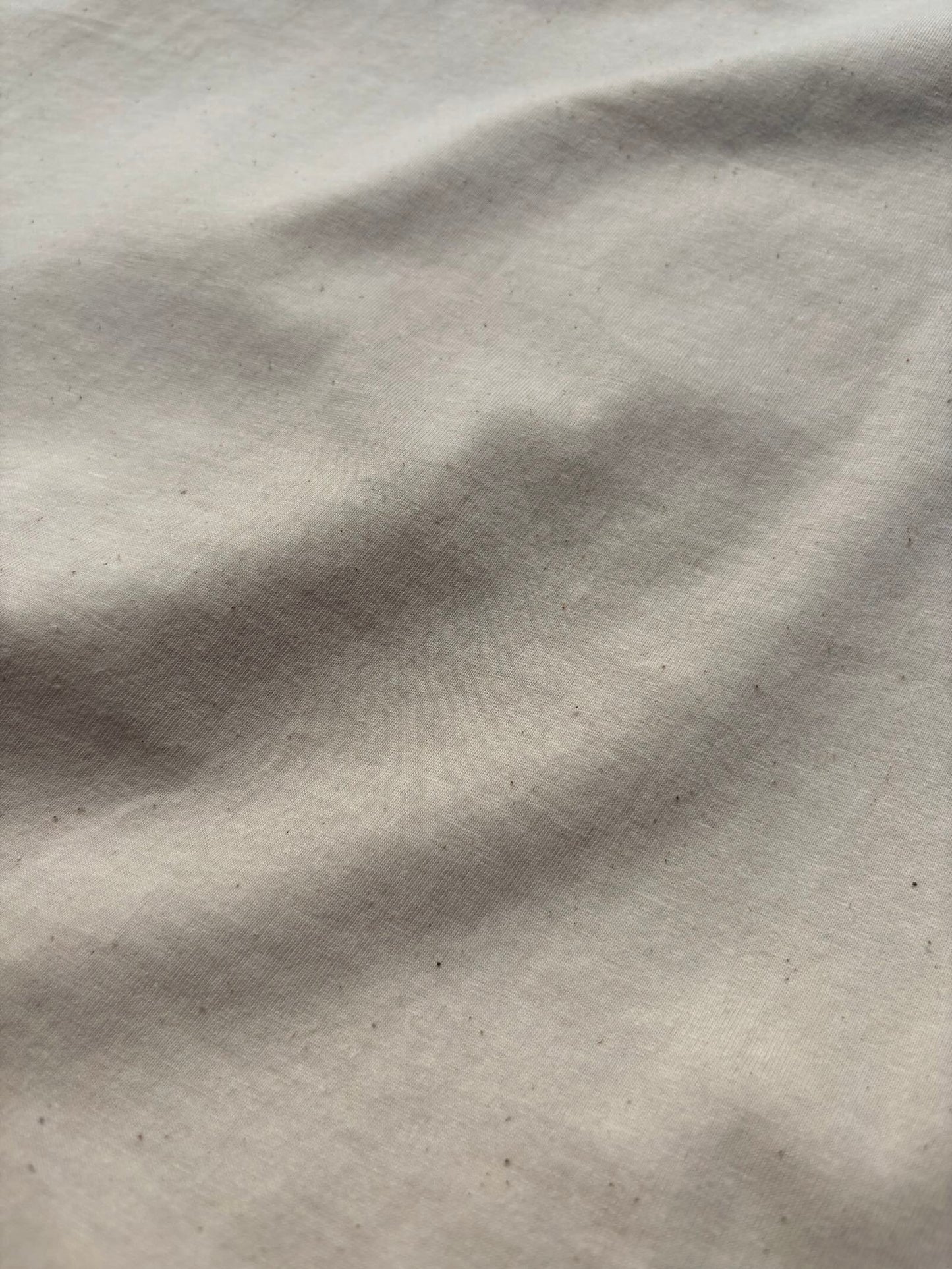 Close-up of Natural Raw organic cotton fabric with natural flecks