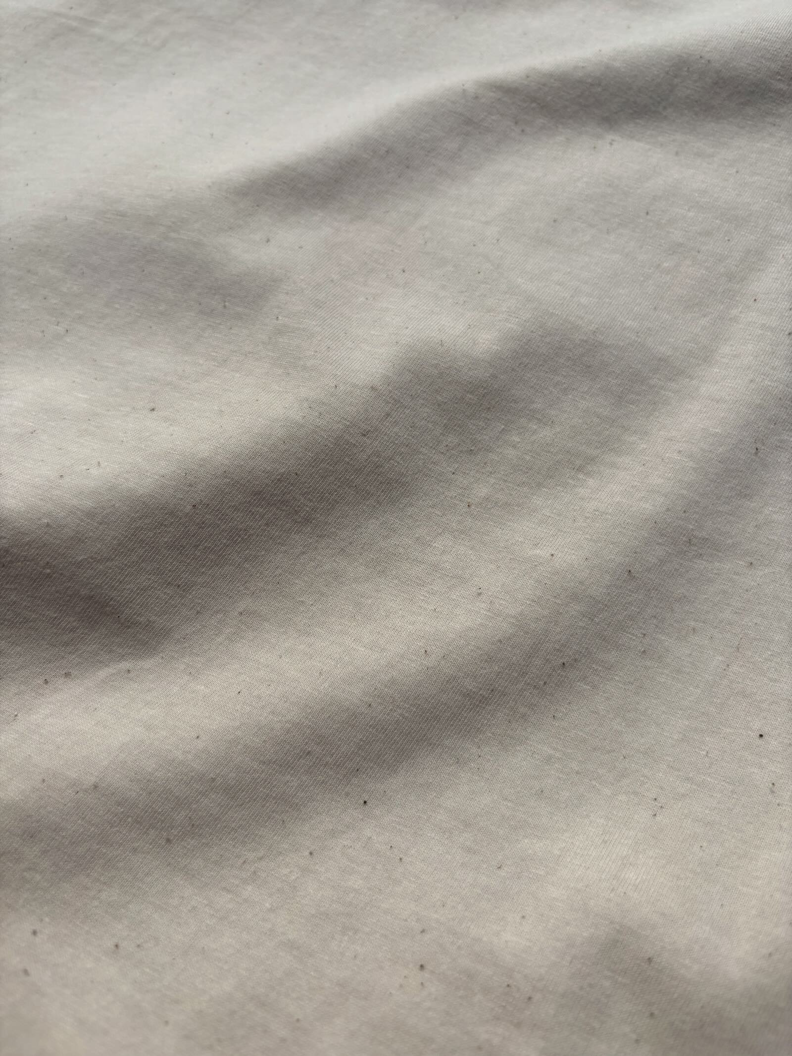 Close-up of Natural Raw organic cotton fabric with natural flecks